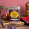 Spice Kitchen's Haggis Seasoning on a colourful background with tartan fabric, a purple ribbon on a chopping board 