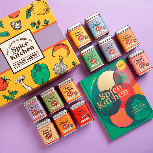 Spice Kitchen Spice Kitchen Signature Spice Blend & Cookery Book Gifting Hamper on a purple background gift box hamper with red ribbon on a purple background