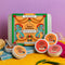 Spice Kitchen Indian Banquet kit with four award-winning spice blends on a yellow surface against a purple background