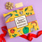 Spice Kitchen Spice Kitchen Signature Spice Blend & Cookery Book Gifting Hamper on a purple background gift box hamper with red ribbon on a purple background