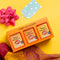 Spice Kitchen Curry Collection packaging with a pink bow on a yellow background