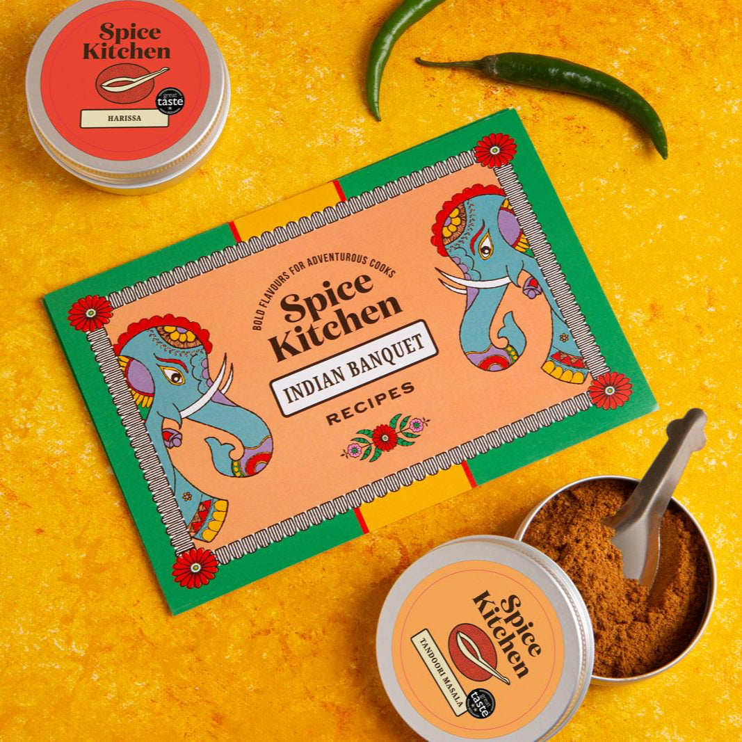 Spice Kitchen recipe book from their Indian Banquet Feasting Kit on a yellow background