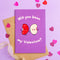 Purple Valentine's Day card with cartoon beans and 'Will you bean my Valentine?' text, surrounded by heart-shaped confetti on a purple background.