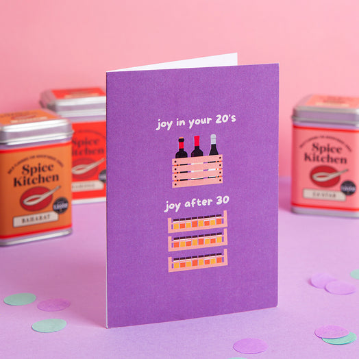 Purple funny birthday card with text and spice rack illustrations on a pink background with Spice Kitchen tins.
