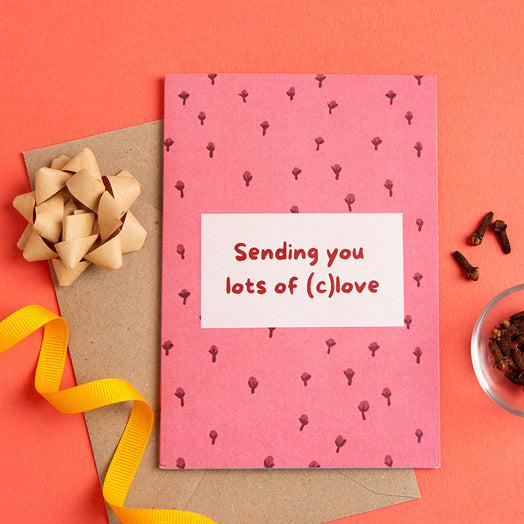Pink card with 'Sending you lots of (c)love' text on a red background with decorative elements.