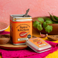 Spice Kitchen Baharat spice blends with a spoon on a pink background