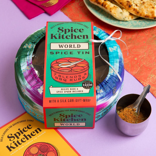 Spice Kitchen World Spice Tin with packaging and a small container of spices on a colorful background.
