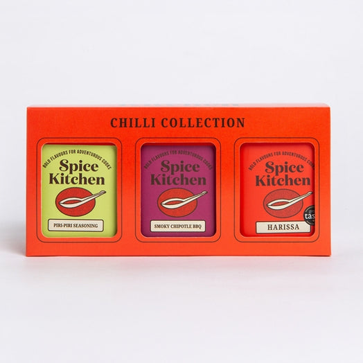 A Spice Kitchen 'Chilli Collection' gift box containing three spice blends: Piri Piri Seasoning, Smoky Chipotle BBQ and Harissa, in a bright orange-red box.