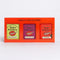 A Spice Kitchen 'Chilli Collection' gift box containing three spice blends: Piri Piri Seasoning, Smoky Chipotle BBQ and Harissa, in a bright orange-red box.