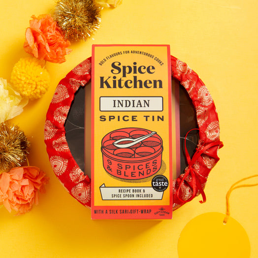 Spice Kitchen Indian Spice Tin on a yellow background with decorative festive elements for gifting