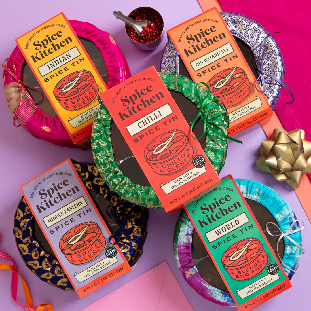 Spice Kitchen's spice tins on a colourful background