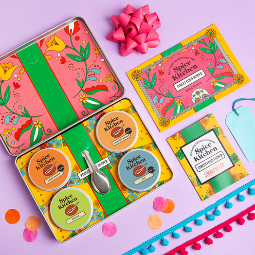 Spice Kitchen\'s Street Food Supper Feasting Kit on a purple background with gifting elements